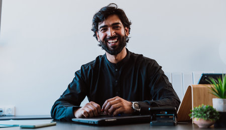 Pakistani Business man in the office. Young business man with traditional outfit working in his office.の写真素材