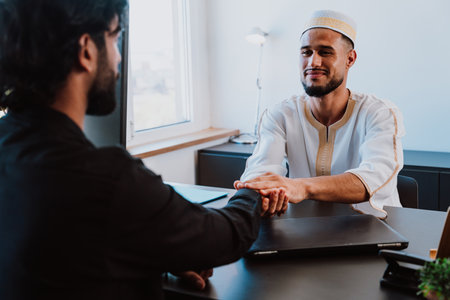 Moroccan Business man in the office. Young business man with traditional outfit working in his office. Salesman speaking with his client.の写真素材