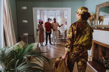 Us Veteran woman homecoming. Young woman coming back to her family from military service for holidays. Female soldier going back home to spend time with relatives.の写真素材