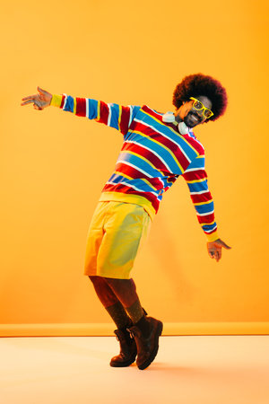 African man portrait in studio on colorful background - Cool black young male with stylish attire...