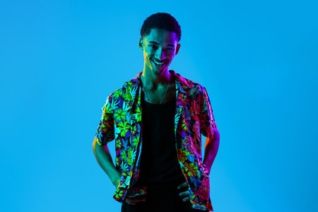 Young portrait in studio on colorful background - Cool black male with stylish attire posing,...