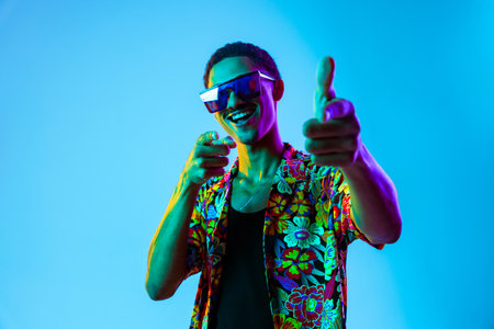 African man young portrait in studio on colorful background - Cool black young male with stylish...