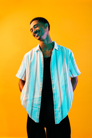 African young man portrait in studio on colorful background - Cool black young male with stylish...