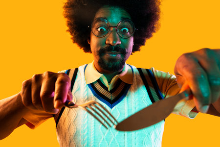 African man portrait in studio on colorful background - Cool black young male with stylish attire posing, creative colored lightingの写真素材