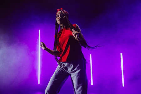 Hip hop dancer dancing in a cool studio with neon lights.