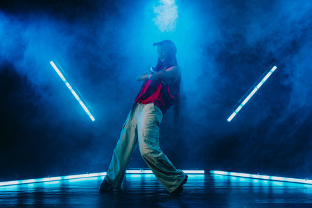 Hip hop dancer dancing in a cool studio with neon lights.