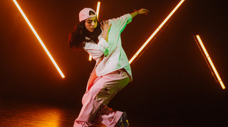 Hip hop dancer dancing in a cool studio with neon lights.