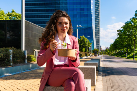 Beautiful young corporate businesswoman wearing colorful elegant suit strolling in the city - Cheerful caucasian woman going to work at the officeの写真素材