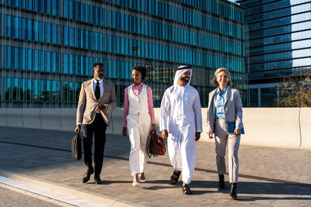 Group of multiethnic business people meeting an emirate businessman - International corporate business team bonding outdoors in the cityの写真素材