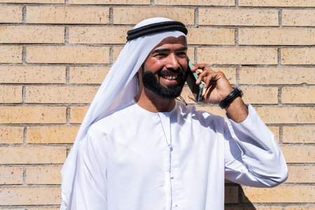 Portrait of arab businessman wearing traditional emirates kandura - Middle-eastern adult male with...