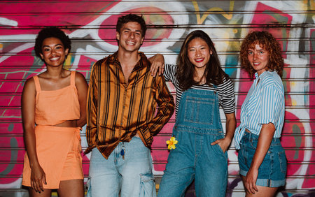 Group of friends going out in the evening and having party. Young people meeting outdoors in the...