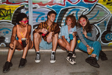 Group of friends going out in the evening and having party. Young people meeting outdoors in the...