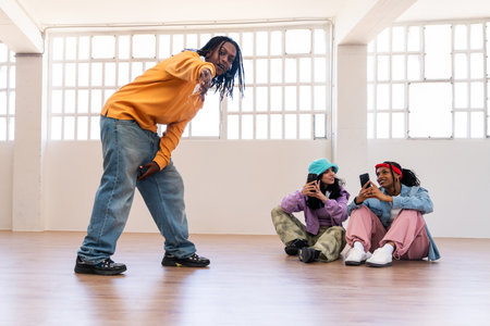 Young group of multiethnic hip-hop dancers wearing colorful urban streetwear dancing - Stylish multiracial rap crew portrait in the dance studioの写真素材