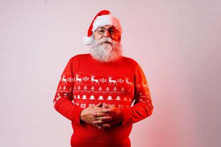 Senior old man with gray beard with Santa Claus portrait in studio - Funny stylish older male adult with cool style, concepts about elderly, lifestyle and Christmasの写真素材