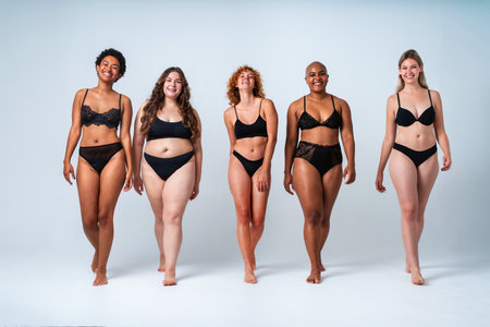 Multiethnic group of women wearing underwear with diverse kind of bodies posing in studio to celebrate diversity and self esteem - body positive, authenticity, women's power and body acceptance conceptsの写真素材