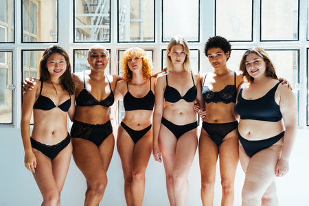 Multiethnic group of women wearing underwear with diverse kind of bodies posing in studio to celebrate diversity and self esteem - body positive, authenticity, women's power and body acceptance conceptsの写真素材