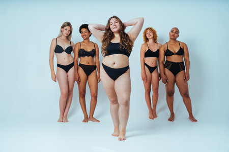 Multiethnic group of women wearing underwear with diverse kind of bodies posing in studio to celebrate diversity and self esteem - body positive, authenticity, women's power and body acceptance conceptsの写真素材