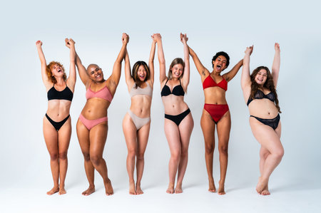 Multiethnic group of women wearing underwear with diverse kind of bodies posing in studio to celebrate diversity and self esteem - body positive, authenticity, women's power and body acceptance conceptsの写真素材