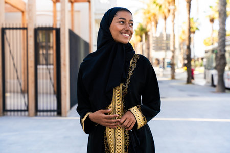 Traditional arab woman wearing emirates abaya outdoors - Beautiful middle-eastern adult female...