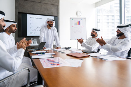 Arab businessmen wearing emirati kandura meeting in office for business deal - Corporate business group of middle-eastern people working in an international company in middle eastの写真素材