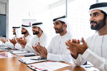 Arab businessmen wearing emirati kandura meeting in office for business deal - Corporate business group of middle-eastern people working in an international company in middle eastの写真素材