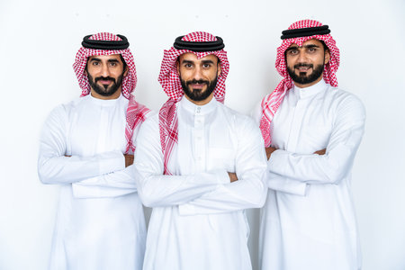 Arab businessmen wearing saudi kandura meeting in office for business deal - Corporate business group of middle-eastern people working in an international companyの写真素材