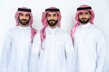 Arab businessmen wearing saudi kandura meeting in office for business deal - Corporate business group of middle-eastern people working in an international company in middle eastの写真素材