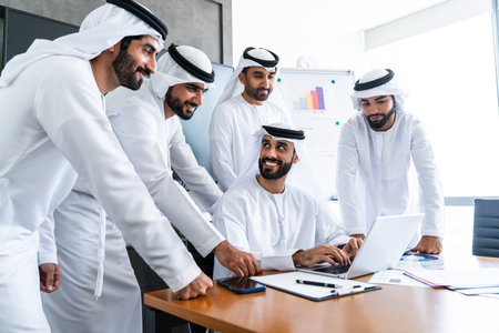 Arab businessmen wearing emirati kandura meeting in office for business deal - Corporate business group of middle-eastern people working in an international company in middle eastの写真素材