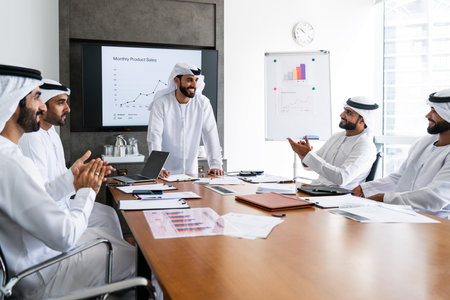 Arab businessmen wearing emirati kandura meeting in office for business deal - Corporate business group of middle-eastern people working in an international company in middle eastの写真素材