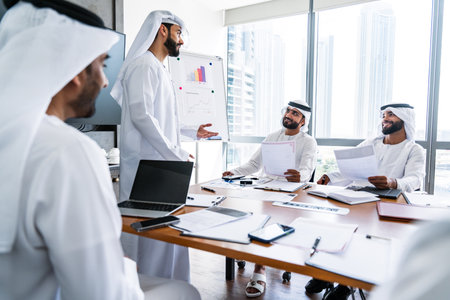 Arab businessmen wearing emirati kandura meeting in office for business deal - Corporate business group of middle-eastern people working in an international company in middle eastの写真素材