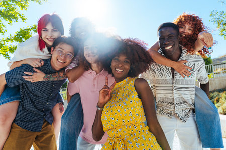 Multiethnic group of young friends meeting and having fun outdoors - Multiracial happy and stylish teen students bonding in the city, concepts about youth, teenagers lifestyle and diversityの写真素材