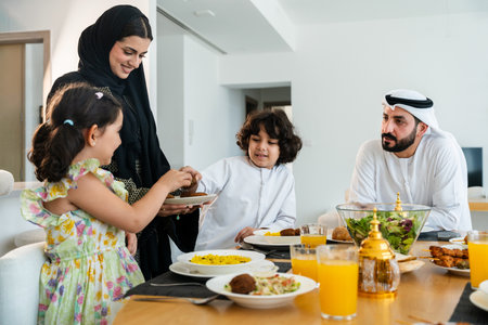 Happy arab family wearing emirati clothing spending time together at home during dinner after...