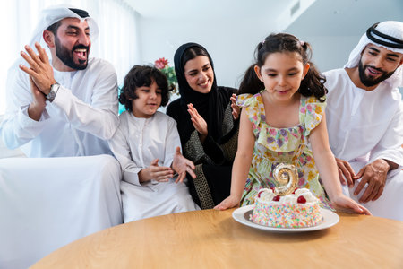 Happy arab family wearing emirati clothing spending time together at home - Middle-eastern parents...