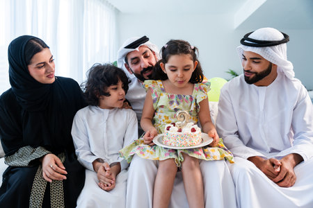 Happy arab family wearing emirati clothing spending time together at home - Middle-eastern parents...