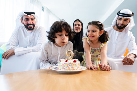Happy arab family wearing emirati clothing spending time together at home - Middle-eastern parents...