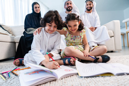 Happy arab family wearing emirati clothing spending time together at home - Middle-eastern parents and children bonding in modern apartment in Dubaiの写真素材