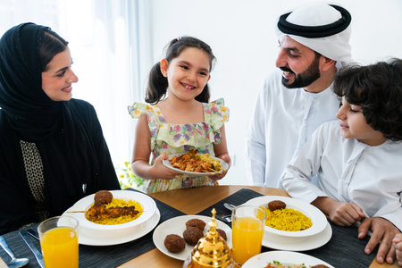 Happy arab family wearing emirati clothing spending time together at home during dinner after...