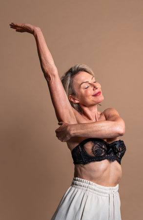 Beauty portrait of beautiful mature woman, concepts about cosmetics, skincare and wellness. Mature woman embracing body positivityの写真素材