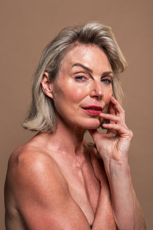 Beauty portrait of beautiful mature woman, concepts about cosmetics, skincare and wellness. Mature woman radiating confidence and natural beauty. Embodying grace. Self-careの写真素材