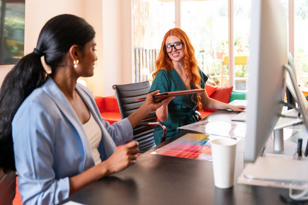 Multiethnic small group of businesspeople meeting in a coworking corporate company office - Young coworkers colleagues working together in a creative startup tech company, concepts about business and daily office lifestyleの写真素材