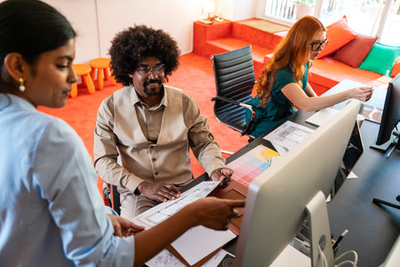 Multiethnic small group of businesspeople meeting in a coworking corporate company office - Young coworkers colleagues working together in a creative startup tech company, concepts about business and daily office lifestyleの写真素材