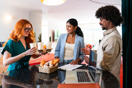 Multiethnic small group of businesspeople meeting in a coworking corporate company office - Young coworkers colleagues working together in a creative startup tech company, concepts about business and daily office lifestyleの写真素材