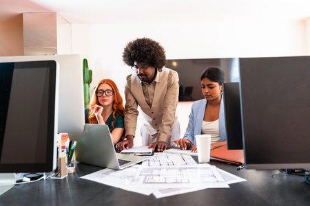 Multiethnic small group of businesspeople meeting in a coworking corporate company office - Young coworkers colleagues working together in a creative startup tech company, concepts about business and daily office lifestyleの写真素材