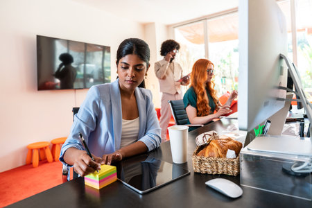 Multiethnic small group of businesspeople meeting in a coworking corporate company office - Young coworkers colleagues working together in a creative startup tech company, concepts about business and daily office lifestyleの写真素材
