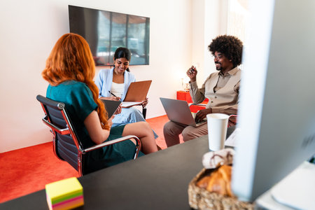 Multiethnic small group of businesspeople meeting in a coworking corporate company office - Young...