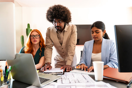 Multiethnic small group of businesspeople meeting in a coworking corporate company office - Young coworkers colleagues working together in a creative startup tech company, concepts about business and daily office lifestyleの写真素材