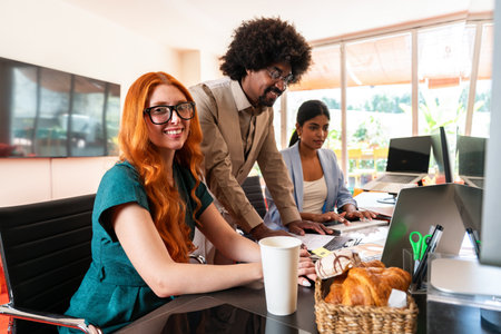 Multiethnic small group of businesspeople meeting in a coworking corporate company office - Young coworkers colleagues working together in a creative startup tech company, concepts about business and daily office lifestyleの写真素材