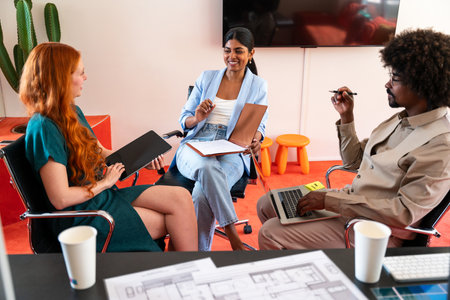 Multiethnic small group of businesspeople meeting in a coworking corporate company office - Young...