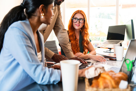 Multiethnic small group of businesspeople meeting in a coworking corporate company office - Young coworkers colleagues working together in a creative startup tech company, concepts about business and daily office lifestyleの写真素材