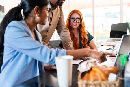 Multiethnic small group of businesspeople meeting in a coworking corporate company office - Young coworkers colleagues working together in a creative startup tech company, concepts about business and daily office lifestyleの写真素材